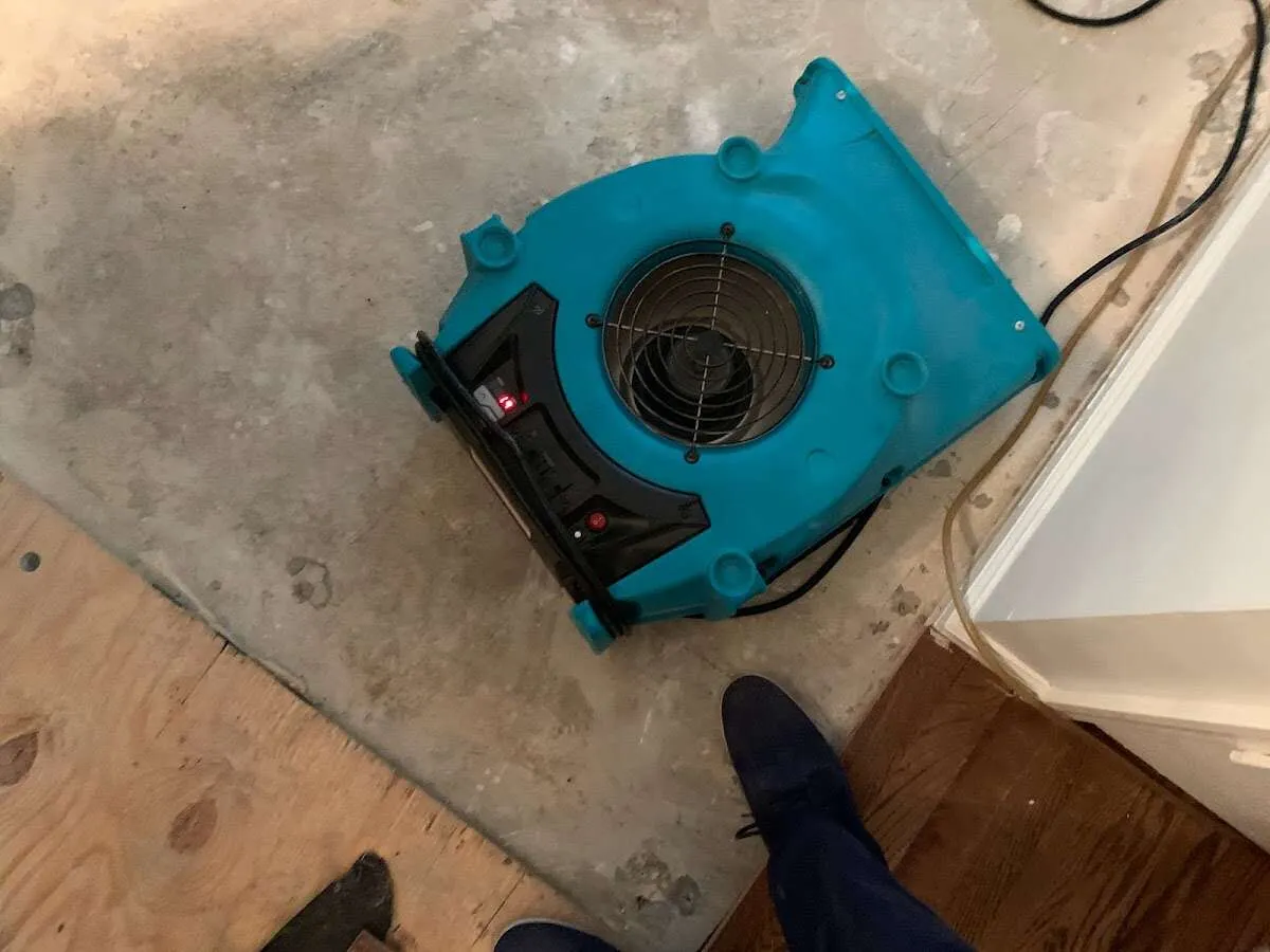 Air mover drying subfloor during Commercial Water Damage Restoration in North Whitehall